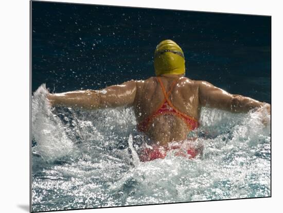 Young Woman Swimming the Butterfly Stroke in a Swimming Pool, Bainbridge Island, Washington, USA-null-Mounted Photographic Print