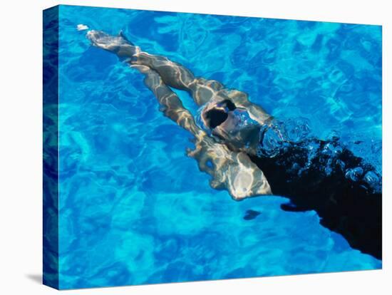 Young Woman Swimming Underwater in a Swimming Pool-null-Stretched Canvas