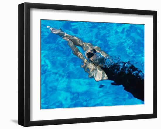 Young Woman Swimming Underwater in a Swimming Pool-null-Framed Photographic Print