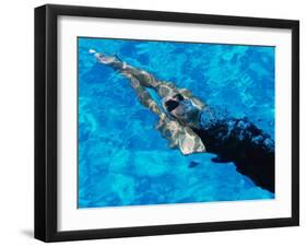 Young Woman Swimming Underwater in a Swimming Pool-null-Framed Photographic Print