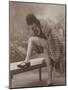 Young Woman Wearing a Fur Coat Cloche Hat and T-Bar Shoes Lifts Her Leg Up-null-Mounted Photographic Print