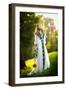 Young Woman Wearing a Long White Dress Holding a Sunflower Outdoor Shot. Portrait of Beautiful Girl-iancucristi-Framed Photographic Print