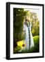 Young Woman Wearing a Long White Dress Holding a Sunflower Outdoor Shot. Portrait of Beautiful Girl-iancucristi-Framed Photographic Print