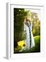 Young Woman Wearing a Long White Dress Holding a Sunflower Outdoor Shot. Portrait of Beautiful Girl-iancucristi-Framed Photographic Print