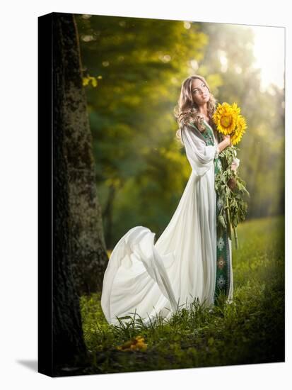 Young Woman Wearing a Long White Dress Holding Sunflowers Outdoor Shot. Portrait of Beautiful Blond-iancucristi-Stretched Canvas