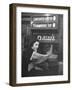 Young Woman Wearing a Winter Coat and Hat, Reading Beneath "D 6th Avenue" Sign, Riding the Subway-Eliot Elisofon-Framed Photographic Print