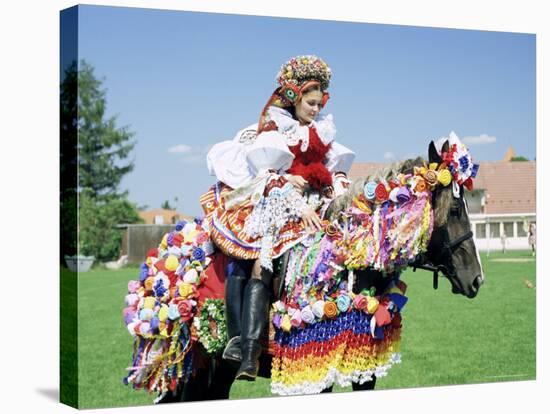 Young Woman Wearing Folk Dress on Horseback, Ride of the Kings Festival, Village of Vlcnov, Vlcnov-Richard Nebesky-Stretched Canvas