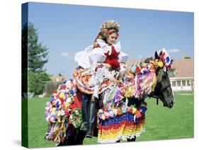 Young Woman Wearing Folk Dress on Horseback, Ride of the Kings Festival, Village of Vlcnov, Vlcnov-Richard Nebesky-Stretched Canvas