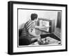 Young Woman with Short Dark Hair Wearing a Stripy Mini Dress Adjusts Her Television Set-null-Framed Art Print