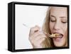 Young Womand Eating Cornflakes from a Spoon-null-Framed Stretched Canvas