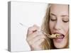 Young Womand Eating Cornflakes from a Spoon-null-Stretched Canvas