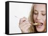 Young Womand Eating Cornflakes from a Spoon-null-Framed Stretched Canvas