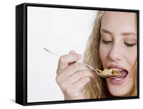 Young Womand Eating Cornflakes from a Spoon-null-Framed Stretched Canvas