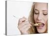 Young Womand Eating Cornflakes from a Spoon-null-Stretched Canvas