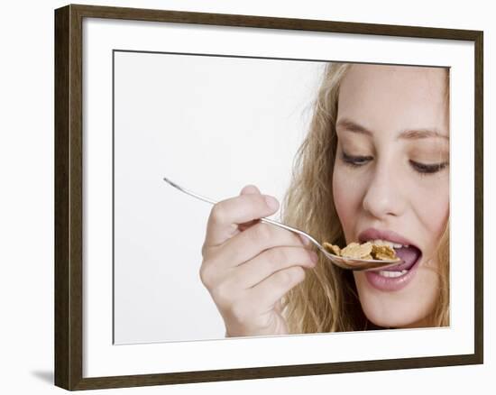 Young Womand Eating Cornflakes from a Spoon-null-Framed Photographic Print