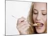Young Womand Eating Cornflakes from a Spoon-null-Mounted Photographic Print