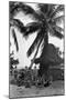 Young Women in Polynesian-Flapper Costumes Lounge under a Coconut Palm-null-Mounted Photographic Print