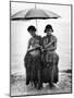 Young Yap Island ladies sporting traditional Grass Skirts, Sharing umbrella in the Caroline Islands-Eliot Elisofon-Mounted Photographic Print