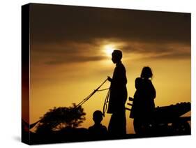 Youth Rides a Donkey Cart Loaded with Other Children, as the Sun Sets on the Outskirts of Islamabad-null-Stretched Canvas