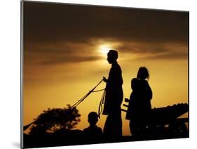 Youth Rides a Donkey Cart Loaded with Other Children, as the Sun Sets on the Outskirts of Islamabad-null-Mounted Photographic Print