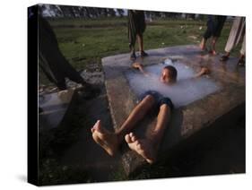 Youth Swims in a Water Reservoir as the Temperature Rises, on the Outskirts of Islamabad, Pakistan-null-Stretched Canvas