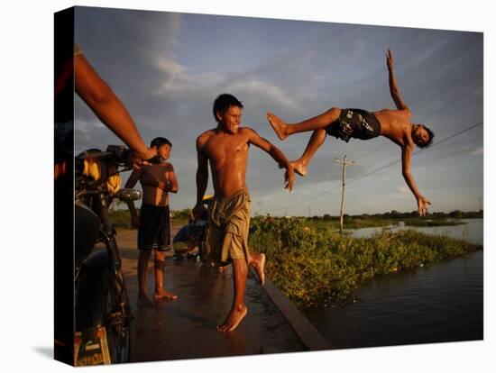 Youths Play in a Lagoon Near the Eastern Beni State Capital of Trinidad, Bolivia-null-Stretched Canvas