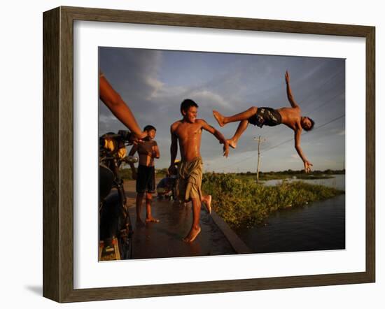 Youths Play in a Lagoon Near the Eastern Beni State Capital of Trinidad, Bolivia-null-Framed Photographic Print