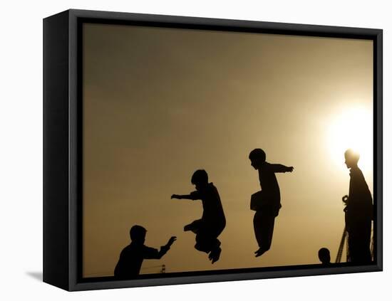 Youths Play on a Trampoline at Sunset in the Neighborhood of Islamabad, Pakistan-null-Framed Stretched Canvas