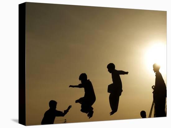 Youths Play on a Trampoline at Sunset in the Neighborhood of Islamabad, Pakistan-null-Stretched Canvas