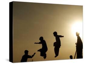 Youths Play on a Trampoline at Sunset in the Neighborhood of Islamabad, Pakistan-null-Stretched Canvas