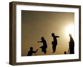 Youths Play on a Trampoline at Sunset in the Neighborhood of Islamabad, Pakistan-null-Framed Photographic Print