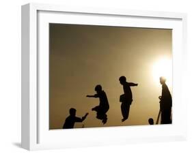 Youths Play on a Trampoline at Sunset in the Neighborhood of Islamabad, Pakistan-null-Framed Photographic Print