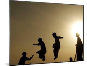 Youths Play on a Trampoline at Sunset in the Neighborhood of Islamabad, Pakistan-null-Mounted Photographic Print