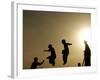 Youths Play on a Trampoline at Sunset in the Neighborhood of Islamabad, Pakistan-null-Framed Photographic Print