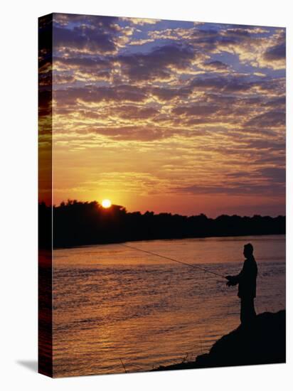 Zambezi National Park, Sausage Tree Camp, Fly-Fishing for Tiger Fish at Sunset on River, Zambia-John Warburton-lee-Stretched Canvas