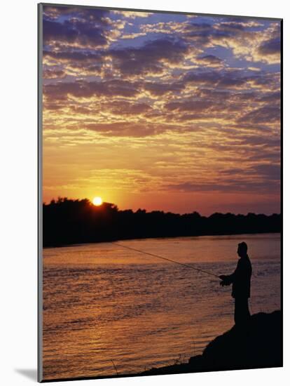 Zambezi National Park, Sausage Tree Camp, Fly-Fishing for Tiger Fish at Sunset on River, Zambia-John Warburton-lee-Mounted Photographic Print