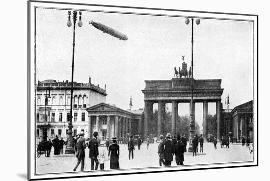 Zeppelin Airship Passing over Brandenburg Gate, Berlin, First World War, 1914-null-Mounted Giclee Print