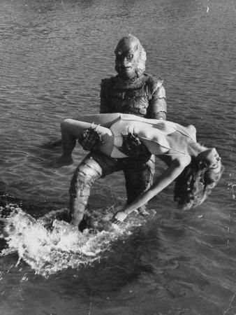 'Actress Julia Adams is Carried by Monster, Gill Man, in the Movie