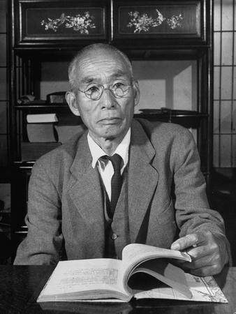 'Former Admiral Takeo Kurita Sitting Behind Desk' Photographic Print
