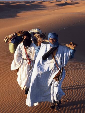 'Berber Tribesmen Lead their Camels Through the Sand Dunes of the Erg
