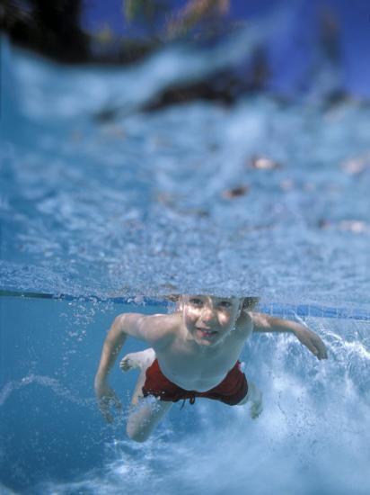 little boy swimming underwater
