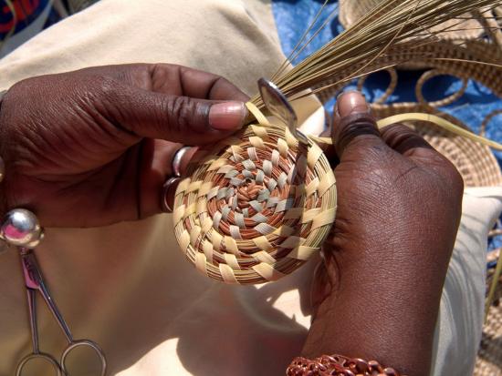 African American Woman Basket Weaves On Market Street In