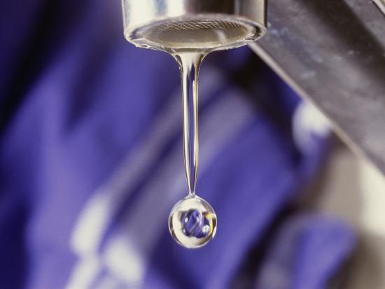 A Close Up Of A Faucet With A Single Drop Of Water Coming Out Of