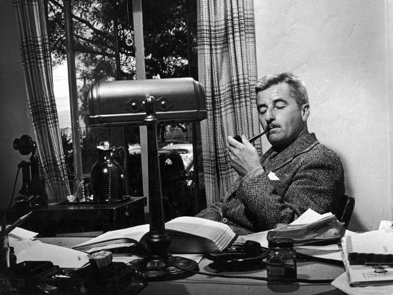 Novelist And Script Writer William Faulkner Smoking A Pipe At His