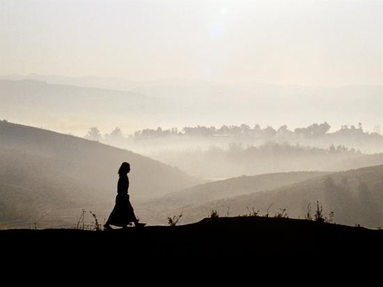 Image result for a woman standing on a hill with light