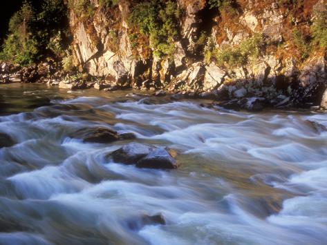 The Payette River Flows By With Lit Rock Wall Behind Idaho Usa