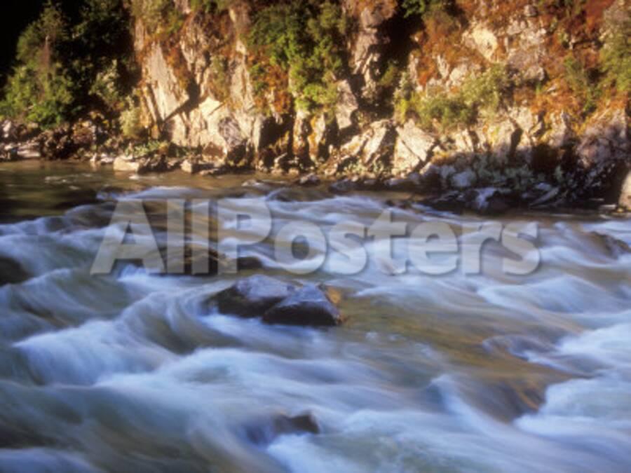 The Payette River Flows By With Lit Rock Wall Behind Idaho Usa
