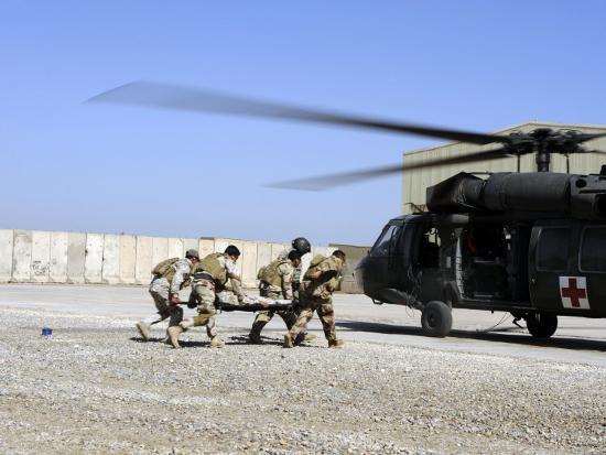 Soldiers Rush A Simulated Casualty To A Uh 60 Blackhawk Helicopter