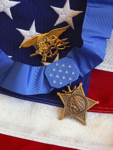 The Medal of Honor Rests On a Flag Beside a SEAL Trident Photographic