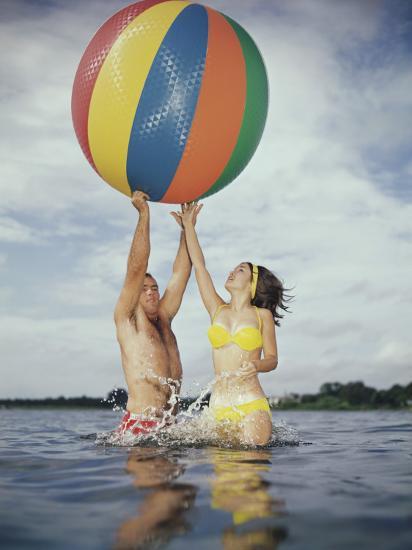 Jumping In Water Reaching For Large Beach Ball Photographic Jumping In Water Reaching For Large Beach Ball